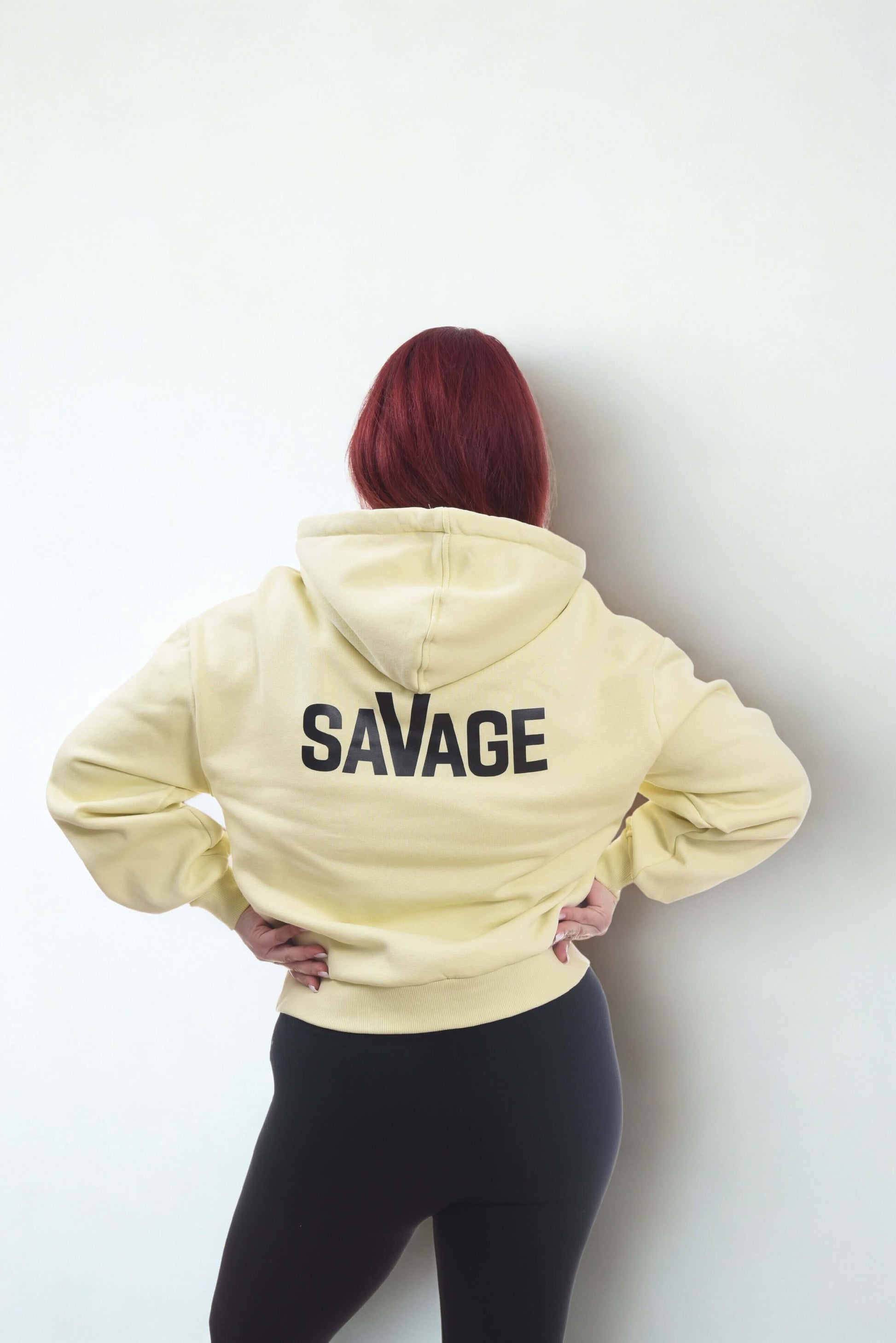 Cropped oversized hoodie in yellow with the word 'SAVAGE' on the back, featuring a relaxed fit and comfortable design.