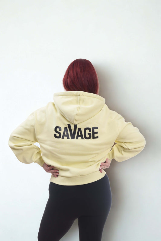 Cropped oversized hoodie in yellow with the word 'SAVAGE' on the back, featuring a relaxed fit and comfortable design.