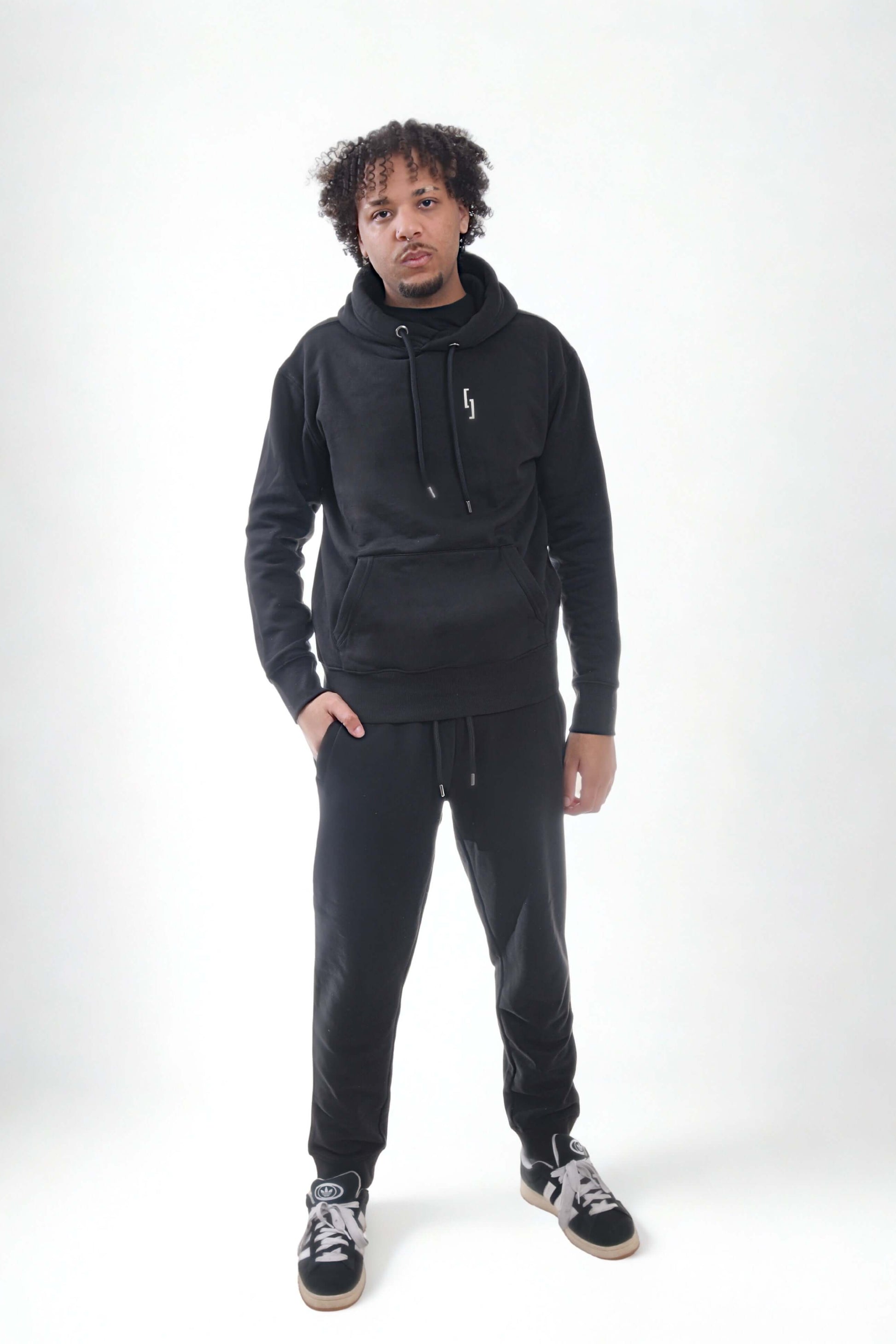 Model wearing heavyweight joggers and hoodie from Raw Line collection, showcasing comfort and style.