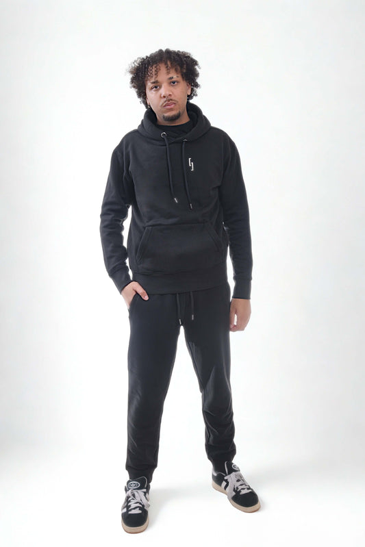 Model wearing heavyweight joggers and hoodie from Raw Line collection, showcasing comfort and style.