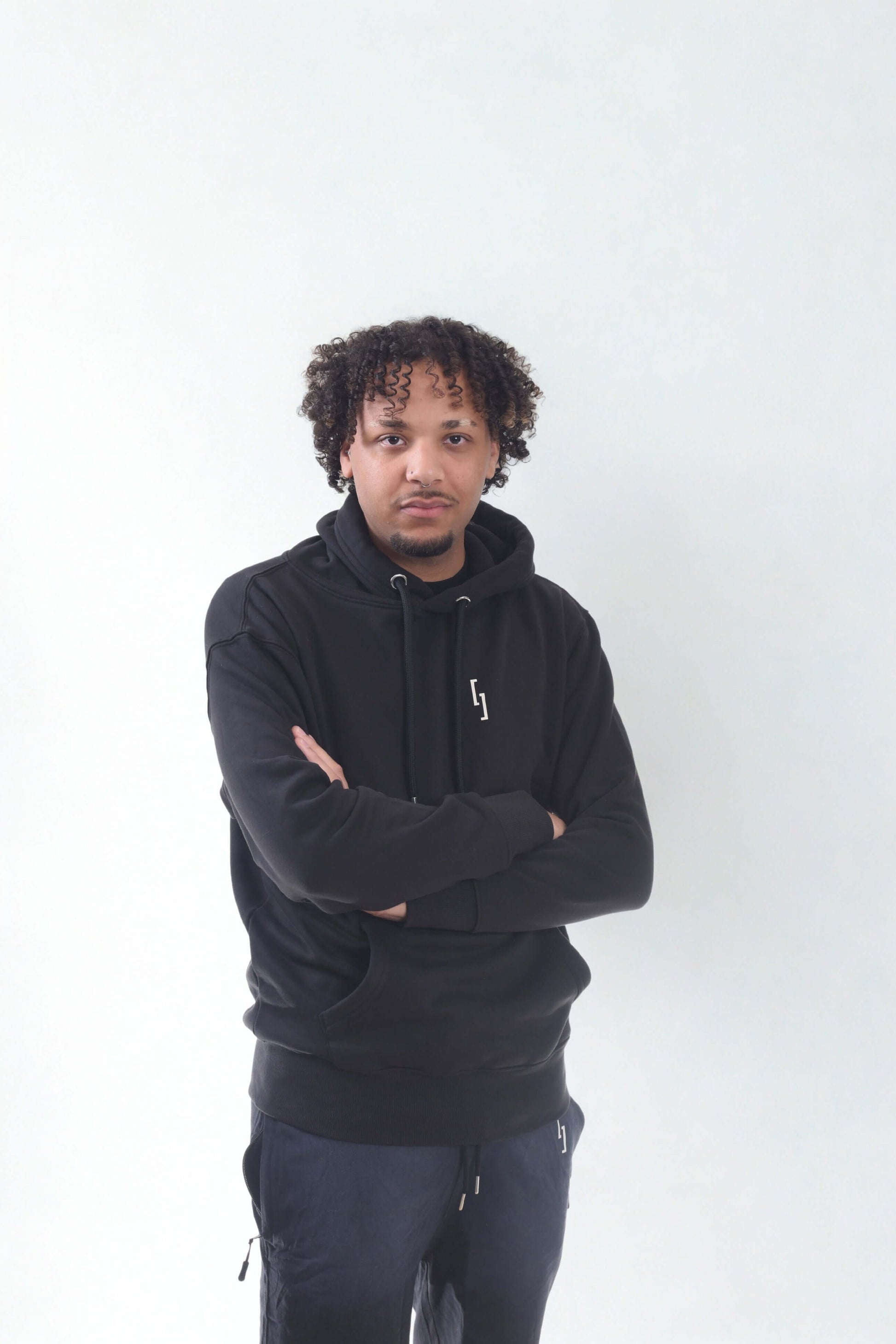 Heavyweight hoodie - RAW LINE model wearing a black slim fit hoodie against a light background.