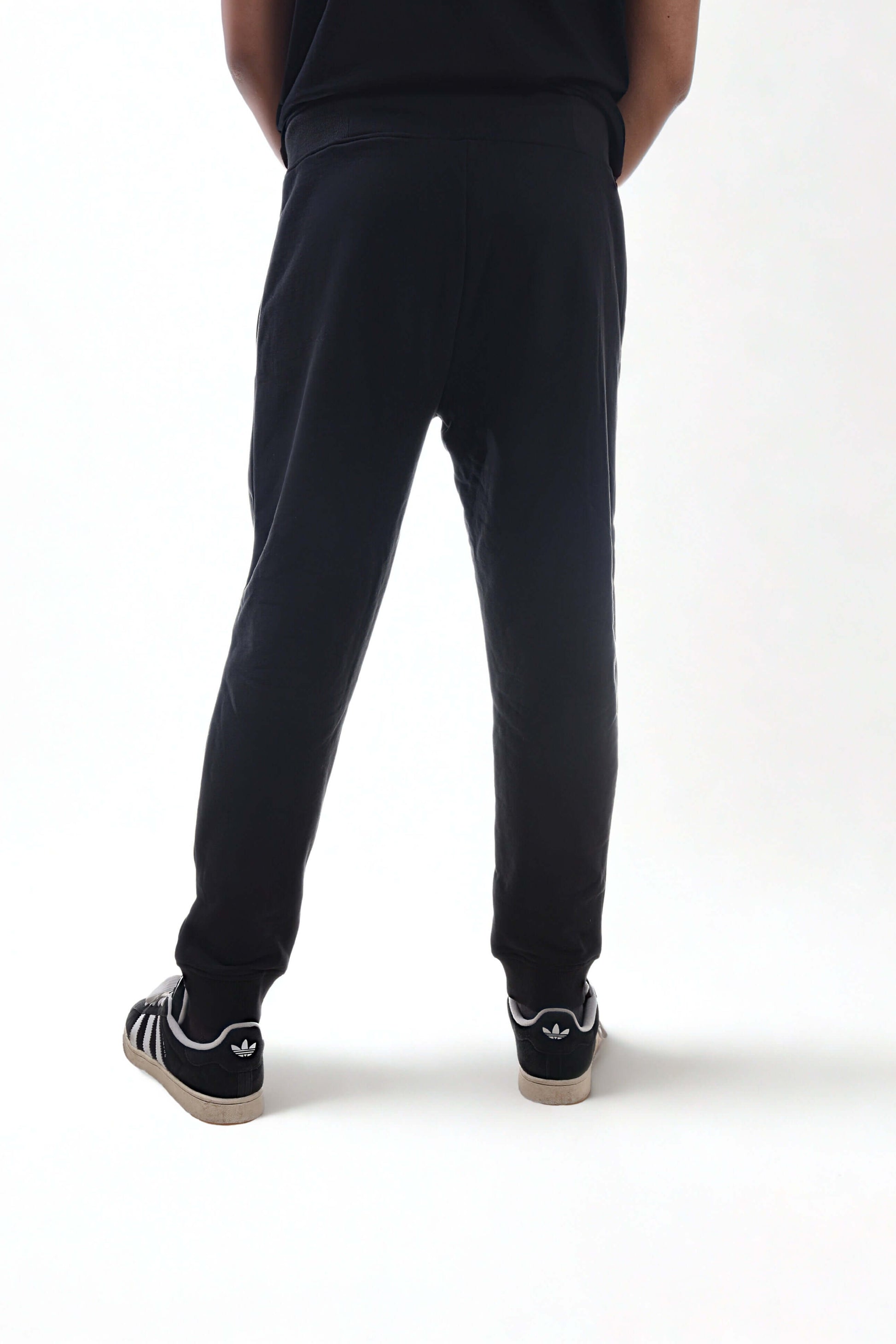 User wearing heavyweight joggers from the back, showcasing the fitted design and comfort of the RAW LINE collection.
