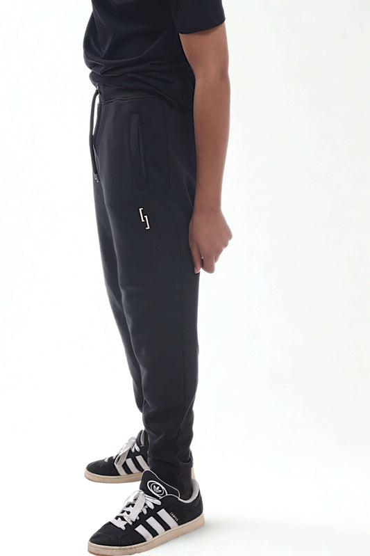 Heavyweight joggers in black worn by a person, featuring a comfortable fit and stylish design.