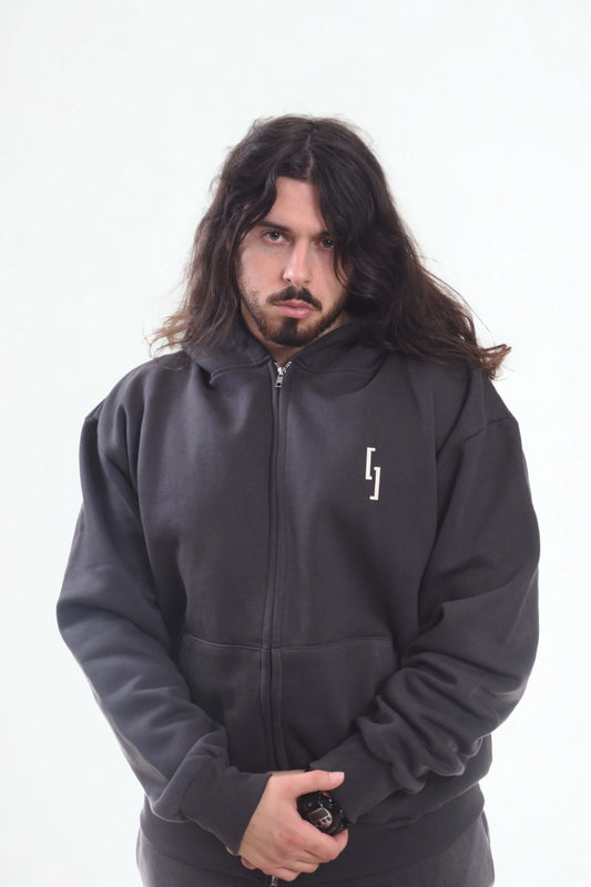 Model wearing heavyweight oversized zipper hoodie from Krow line, showcasing streetwear style.