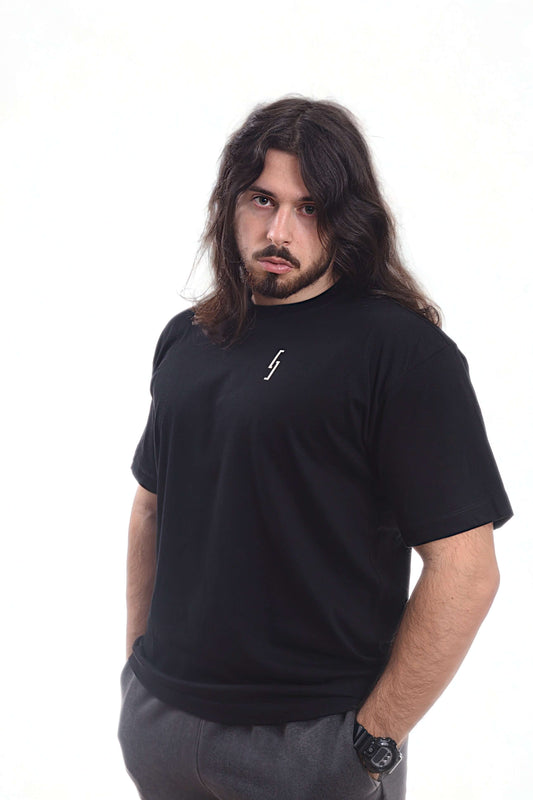 A man wearing a heavyweight t shirt in black, showcasing a relaxed fit and unique design.