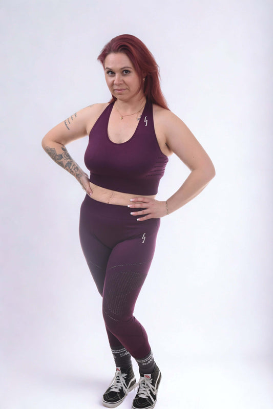 Model wearing performance leggings - RAW FORGED in purple, showcasing flexibility and style, ideal for training.