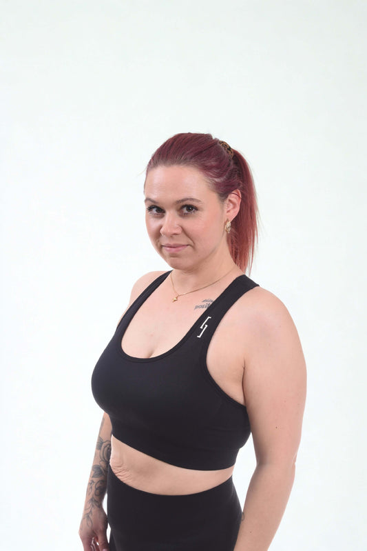 Woman wearing a performance sports bra - RAW UNLEASHED, showcasing seamless design and supportive fit.