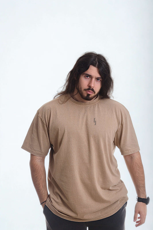 Model wearing a vintage oversized shirt in beige color, showcasing a casual style with comfort and subtle design.