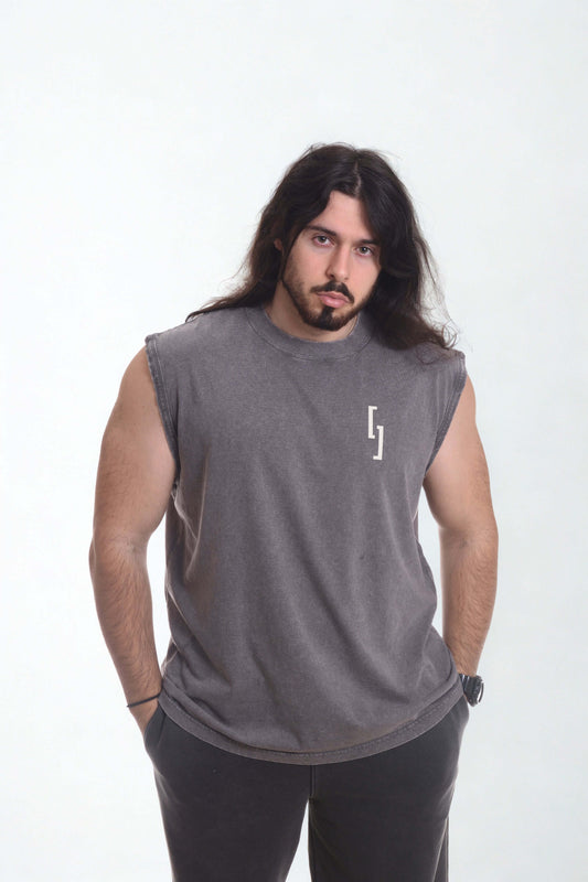 Man wearing a vintage oversized tanktop in gray color, showcasing vintage vibes and casual style.