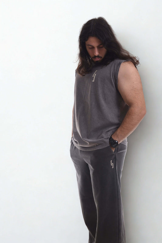 Model wearing vintage ribbed cuff pants with a sleeveless top, showcasing street style and comfort.