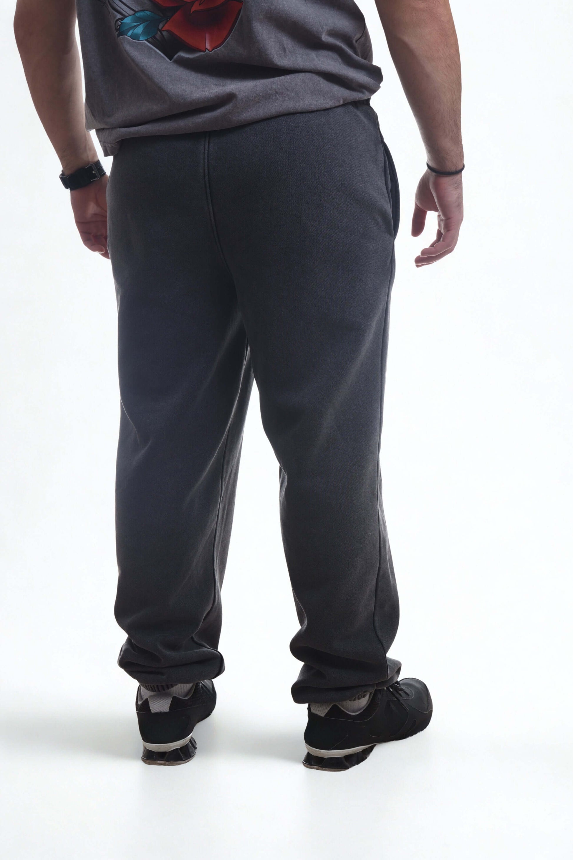 Back view of a person wearing vintage ribbed cuff pants in dark color, showcasing comfort and style.