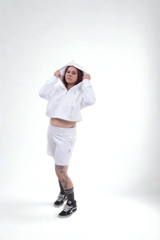Athletic comfort zip hoodie worn by a model in a white outfit, showcasing gym-to-street style and recovery-ready comfort.